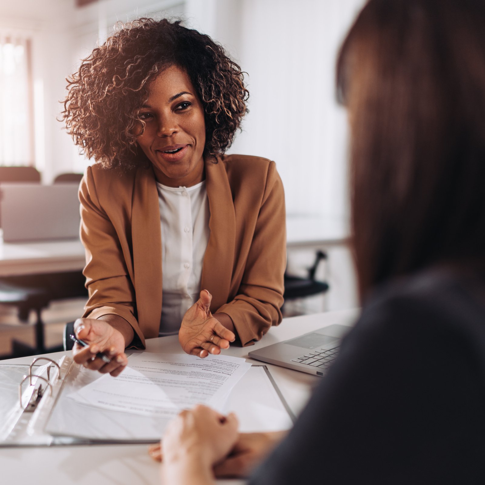 Woman consulting with a female agent